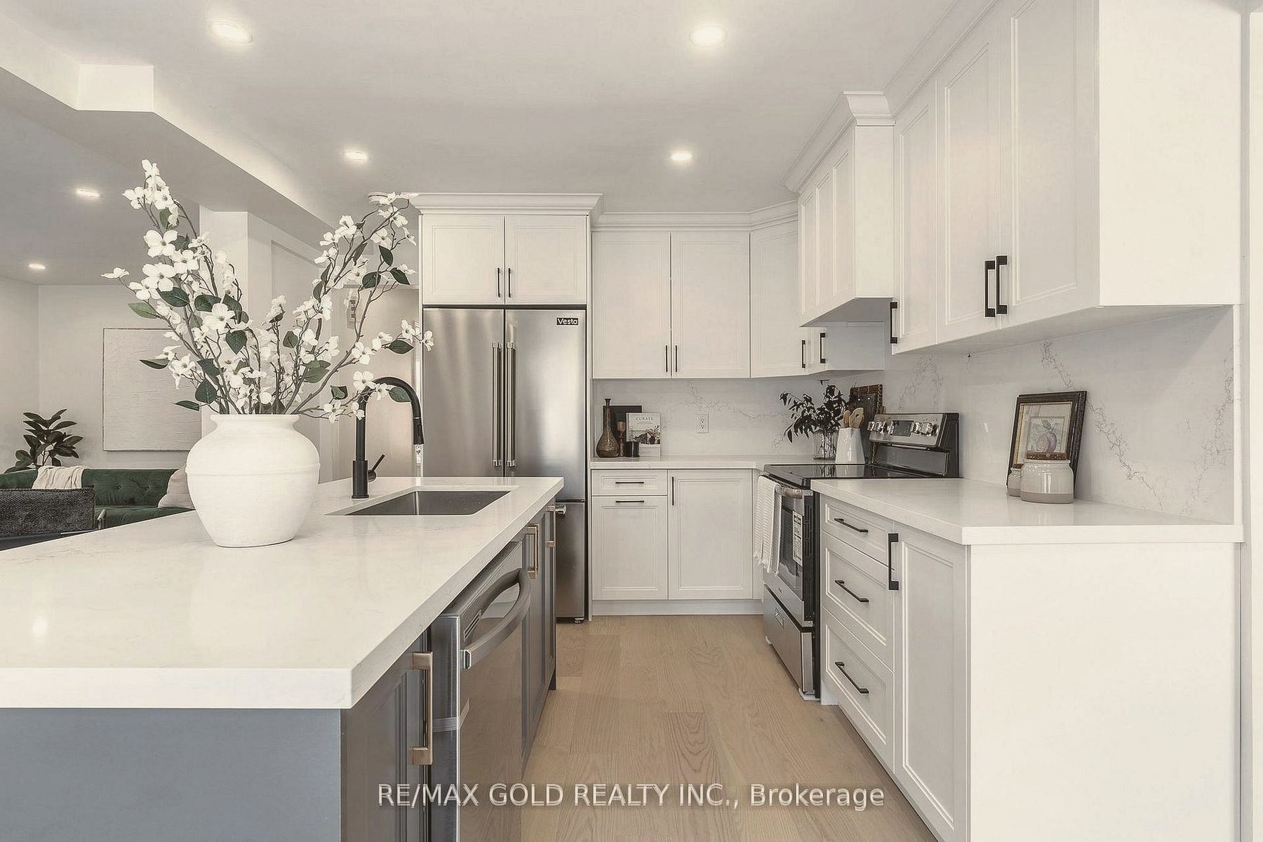 Kitchen island styled with a white vase of blossom branches