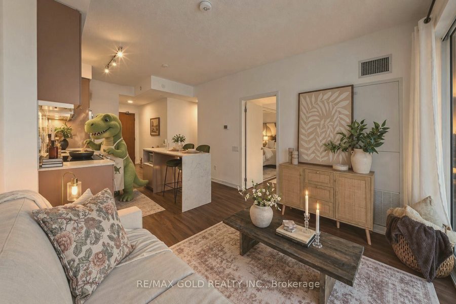 Condo living room with a linen sofa, rattan console and candlelit coffee table
